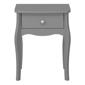 Baroque Nightstand Folkestone Grey with Rose Gold Colour Handles Furniture To Go 1013760010072G 5707252076351 Introduce elegance to your bedroom with our Baroque one drawer nightstand, inspired by the charming Provence style. This stunning piece features delicate detailing, a soft Grey finish, and rose gold colour handles that beautifully complement any room decor. With its spacious drawer, it offers ample storage space for your makeup, jewellery, or other essentials, keeping them tidy and easily accessible