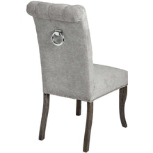 Load image into Gallery viewer, Silver Roll Top Dining Chair With Ring Pull in GREY Hill Interiors 18331 5050140833193 Sumptuous and luxurious design Handcrafted Beautifully made and incredibly stylish White glove delivery Dimensions: 105cm x 49cm x 71cm Weight: 8.6kg Volume: 0.26CBM This is item is built with a Rubberwood Frame, Known for its dense grain and strength, it is perfect for this item. The Fabric is comprised of Nylon and Polyester. All upholstered items have passed UK fire safety regulations with cigarette and match test cert