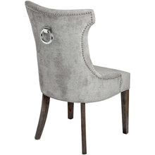 Load image into Gallery viewer, Silver High Wing Ring Backed Dining Chair in SILVER Hill Interiors 18333 5050140833391 Sumptuous and luxurious design Handcrafted Beautifully made and incredibly stylish White glove delivery Dimensions: 102cm x 57cm x 62cm Weight: 10.4kg Volume: 0.28CBM This is item is built with a Rubberwood Frame, Known for its dense grain and strength, it is perfect for this item. The Fabric is comprised of Nylon and Polyester. All upholstered items have passed UK fire safety regulations with cigarette and match test cer