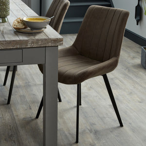 Malmo Grey Dining Chair in GREY Hill Interiors 20046 5050140004685 Scandi styling Handcrafted High quality faux leather Dimensions: 86cm x 49cm x 57cm Weight: 5.4kg Volume: 0.268CBM The Malmo Dining Chair is a handsome addition to a kitchen or dining space. It features a simple design which oozes practicality and comfort too wrapped up in a stylish, neutral grey package with black legs. Be sure to take a look at the tan version too, 20047.
