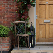 Load image into Gallery viewer, Cross Back Dining Chair in BROWN Hill Interiors 20571 5050140057186 Solid oak Handcrafted White glove delivery Dimensions: 88cm x 42cm x 41cm Weight: 2.2kg Volume: 0.6CBM This is the Cross Back Dining Chair, this seat has been designed in Elm with practicality and comfort in mind, ensuring it would make a great, hard-wearing, dining chair. It features a cross-back design which adds to the comfort of the product while the black finish of the metal gives a subtle industrial feel. The chair has been finished w