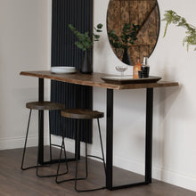 Load image into Gallery viewer, Live Edge Large Bar Table in BLACK Hill Interiors 22701 5050140270189 White glove delivery Dimensions: 100cm x 180cm x 70cm Weight: 50.72kg Volume: 0.44CBM This is the Live Edge Bar Table. Made from Indian hardwood (acacia), this Live Edge bar table is the perfect place to set up your home bar and has a stylish metal base, giving it an industrial luxe style. Elevate your home entertainment set-up with this stylish piece. 

The Live Edge wood creates real charm and character and helps you to bring a feel of 