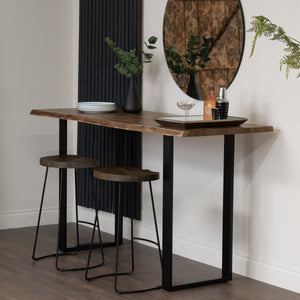 Live Edge Large Bar Table in BLACK Hill Interiors 22701 5050140270189 White glove delivery Dimensions: 100cm x 180cm x 70cm Weight: 50.72kg Volume: 0.44CBM This is the Live Edge Bar Table. Made from Indian hardwood (acacia), this Live Edge bar table is the perfect place to set up your home bar and has a stylish metal base, giving it an industrial luxe style. Elevate your home entertainment set-up with this stylish piece. 

The Live Edge wood creates real charm and character and helps you to bring a feel of 