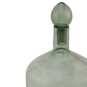 Smoked Sage Glass Bottle With Stopper in SAGE Hill Interiors 22981 5050140298183 Dimensions: 33cm x 18cm x 18cm Weight: 0.85kg Volume: 0.1CBM This is the Smoked Sage Glass Bottle With Stopper. This ornamental glassware is a perfect partner to our new Stamford furniture range, injecting some subtle and soothing tones to its display cabinets and surfaces. Matching taller shaped bottle and stopper available for a beautiful staggered height display.