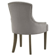Load image into Gallery viewer, Brockham Ashen Dining Chair in GREY Hill Interiors 22987 5050140298787 White glove delivery Dimensions: 96cm x 63cm x 65cm Weight: 11.5kg Volume: 0.33CBM This is the Brockham Ashen Dining Chair. The Brockham dining chair marries comfort with style to deliver a sumptuous and stylish addition to any dining space. Its rubberwood frame, known for its dense grain and strength, is the perfect choice for its intended everyday use. Upholstered in grey woven fabric, its a timeless choice that will suit a wide variet
