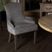 Load image into Gallery viewer, Brockham Ashen Dining Chair in GREY Hill Interiors 22987 5050140298787 White glove delivery Dimensions: 96cm x 63cm x 65cm Weight: 11.5kg Volume: 0.33CBM This is the Brockham Ashen Dining Chair. The Brockham dining chair marries comfort with style to deliver a sumptuous and stylish addition to any dining space. Its rubberwood frame, known for its dense grain and strength, is the perfect choice for its intended everyday use. Upholstered in grey woven fabric, its a timeless choice that will suit a wide variet