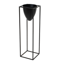 Load image into Gallery viewer, Large Matt Black Bullet Planter On Black Frame in BLACK Hill Interiors 23086 5050140308684 Dimensions: 80cm x 23cm x 23cm Weight: 1.48kg Volume: 0.05CBM This is the Large Black Bullet Planter On Black Frame, a unique and contemporary planter in style and features which is sure to bring an element of design and class into any interior. The black finsh and bullet shade is extremely on trend and when finished with a beautiful bundle of greenery it is sure to create an eye catching piece in any interior. At 80c
