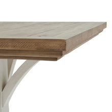 Load image into Gallery viewer, Luna Collection Square Dining Table in WHITE Hill Interiors 23110 5050140311080 Dimensions: 78cm x 90cm x 90cm Weight: 25kg Volume: 0.63CBM This is the Luna Collection Square Dining Table. Where rustic charm meets contemporary design, the furniture range boasts an off white painted bottom combined with a stained wooden top. It is carefully handcrafted by skilled artisans, highlighting a unique planked pine design enhanced by a warm mid-tone stain. The fusion of this earthy texture with popular white painted