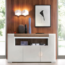 Load image into Gallery viewer, Toronto 3 Door Sideboard with open shelving (inc. Plexi Lighting) In White and Oak Furniture To Go 4202944 5900355035601 3 Door Sideboard with open shelving (inc, Plexi Lighting). This 3 door sideboard has many features including soft close doors. internal LED lighting and adjustable shelves. Warm and yet cool living and dining collection in white High Gloss with San Remo Oak inset. Dimensions: 845mm x 1400mm x 422mm (Height x Width x Depth) 
 Laminated board ( resistant to damage and scratches, moisture an
