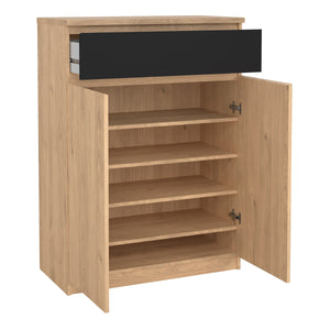 Naia Shoe Cabinet with 2 Doors +1 Drawer in Jackson Hickory Oak & Black Furniture To Go 70292209hlgm 5713035082266 Experience the perfect blend of style and functionality with the Naia Shoe Cabinet. Designed with a sleek combination of Jackson Hickory Oak and Black finishes, this cabinet adds a touch of elegance to your space. Featuring two doors and a convenient black drawer, it offers ample storage for your shoe collection while keeping your entryway neat and organized. With its versatile design and quali