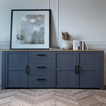 Load image into Gallery viewer, Bohol Large Sideboard in Riviera Oak/Navy Furniture To Go 801bhlk241r-m348 5904767832308 The Bohol collection draws inspiration from its timeless charm and rustic style, embracing its simplicity and natural elegance. What truly sets this collection apart from others is its exquisite decor - featuring three colourways with an Oak finish. The subtle elegance of the light Riviera Oak contributes by adding a focal point to each piece. Also featuring black handles with soft close doors, making it truly stand out