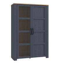 Load image into Gallery viewer, Bohol Display Cabinet in Riviera Oak/Navy Furniture To Go 801bhlv621-m348 5904767832292 The Bohol collection draws inspiration from its timeless charm and rustic style, embracing its simplicity and natural elegance. What truly sets this collection apart from others is its exquisite decor - featuring three colourways with an Oak finish. The subtle elegance of the light Riviera Oak contributes by adding a focal point to each piece. Also featuring black handles with soft close doors, making it truly stand out 