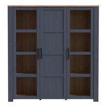 Load image into Gallery viewer, Bohol Large Display Cabinet in Riviera Oak/Navy Furniture To Go 801bhlv631-m348 5904767832285 The Bohol collection draws inspiration from its timeless charm and rustic style, embracing its simplicity and natural elegance. What truly sets this collection apart from others is its exquisite decor - featuring three colourways with an Oak finish. The subtle elegance of the light Riviera Oak contributes by adding a focal point to each piece. Also featuring black handles with soft close doors, making it truly stan