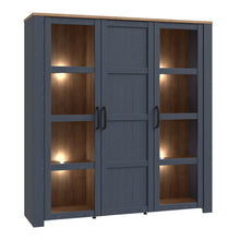 Load image into Gallery viewer, Bohol Large Display Cabinet in Riviera Oak/Navy Furniture To Go 801bhlv631-m348 5904767832285 The Bohol collection draws inspiration from its timeless charm and rustic style, embracing its simplicity and natural elegance. What truly sets this collection apart from others is its exquisite decor - featuring three colourways with an Oak finish. The subtle elegance of the light Riviera Oak contributes by adding a focal point to each piece. Also featuring black handles with soft close doors, making it truly stan