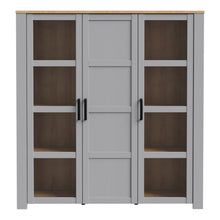 Load image into Gallery viewer, Bohol Large Display Cabinet in Riviera Oak/Grey Oak Furniture To Go 801bhlv631-m478 5904767835118 The Bohol collection draws inspiration from its timeless charm and rustic style, embracing its simplicity and natural elegance. What truly sets this collection apart from others is its exquisite decor - featuring three colourways with an Oak finish. The subtle elegance of the light Riviera Oak contributes by adding a focal point to each piece. Also featuring black handles with soft close doors, making it truly 
