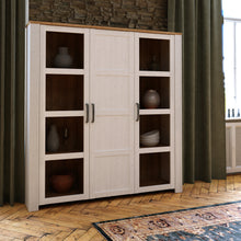 Load image into Gallery viewer, Bohol Large Display Cabinet in Riviera Oak/White Furniture To Go 801bhlv631-m482 5904767840563 The Bohol collection draws inspiration from its timeless charm and rustic style, embracing its simplicity and natural elegance. What truly sets this collection apart from others is its exquisite decor - featuring three colourways with an Oak finish. The subtle elegance of the light Riviera Oak contributes by adding a focal point to each piece. Also featuring black handles with soft close doors, making it truly sta