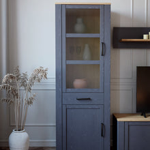Load image into Gallery viewer, Bohol Narrow Display Cabinet in Riviera Oak/Navy Furniture To Go 801bhlv712-m348 5904767832278 The Bohol collection draws inspiration from its timeless charm and rustic style, embracing its simplicity and natural elegance. What truly sets this collection apart from others is its exquisite decor - featuring three colourways with an Oak finish. The subtle elegance of the light Riviera Oak contributes by adding a focal point to each piece. Also featuring black handles with soft close doors, making it truly sta