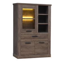 Load image into Gallery viewer, Corona Display Cabinet in Tabak Oak Furniture To Go 801cr2v521l-d64 5904767852689 Discover the captivating allure of the Corona collection, where practicality meets sophistication, the collection offers open recesses, drawers, doors, and shelves. Provide secure and stylish storage solutions with this high-quality selection of furniture. Dimensions: 2120mm x 1084mm x 413mm (Height x Width x Depth) 
 Traditional design 
 Dark warm tabak oak effect 
 , 1 glass door 
 1 drawer 
 3 shelves 
 Optional Lighting 
 