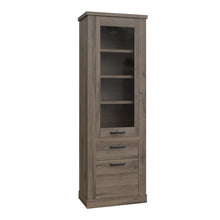 Load image into Gallery viewer, Corona Narrow Display Cabinet in Tabak Oak Furniture To Go 801cr2v812-d64 5904767852719 Discover the captivating allure of the Corona collection, where practicality meets sophistication, the collection offers open recesses, drawers, doors, and shelves. Provide secure and stylish storage solutions with this high-quality selection of furniture. Dimensions: 2120mm x 714mm x 413mm (Height x Width x Depth) 
 Traditional design 
 Dark warm tabak oak effect 
 1 glass door, 1 door 
 1 drawer 
 3 shelves 
 Optional 