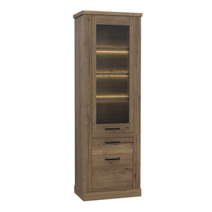 Corona Narrow Display Cabinet in Tabak Oak Furniture To Go 801cr2v812-d64 5904767852719 Discover the captivating allure of the Corona collection, where practicality meets sophistication, the collection offers open recesses, drawers, doors, and shelves. Provide secure and stylish storage solutions with this high-quality selection of furniture. Dimensions: 2120mm x 714mm x 413mm (Height x Width x Depth) 
 Traditional design 
 Dark warm tabak oak effect 
 1 glass door, 1 door 
 1 drawer 
 3 shelves 
 Optional 