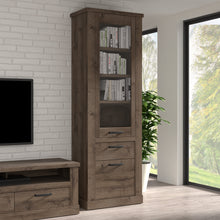 Load image into Gallery viewer, Corona Narrow Display Cabinet in Tabak Oak Furniture To Go 801cr2v812-d64 5904767852719 Discover the captivating allure of the Corona collection, where practicality meets sophistication, the collection offers open recesses, drawers, doors, and shelves. Provide secure and stylish storage solutions with this high-quality selection of furniture. Dimensions: 2120mm x 714mm x 413mm (Height x Width x Depth) 
 Traditional design 
 Dark warm tabak oak effect 
 1 glass door, 1 door 
 1 drawer 
 3 shelves 
 Optional 