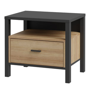 High Rock Bedside in Matt Black/Riviera Oak Furniture To Go 801hrkk011-m197 5904767839635 High Rock, a captivating and contemporary collection which has a perfect blend of the Riviera Oak decor with deep black accents, this collection immediately captivates attention with its originality. The sleek black metal handles add a touch of elegance, while the tables boast robust metal legs in a frame-like design, contributing to a distinct loft character within the space. Beyond its striking aesthetics, High Rock 