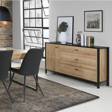 Load image into Gallery viewer, High Rock Sideboard in Matt Black/Riviera Oak Furniture To Go 801hrkk221-m197 5904767825478 High Rock, a captivating and contemporary collection which has a perfect blend of the Riviera Oak decor with deep black accents, this collection immediately captivates attention with its originality. The sleek black metal handles add a touch of elegance, while the tables boast robust metal legs in a frame-like design, contributing to a distinct loft character within the space. Beyond its striking aesthetics, High Roc