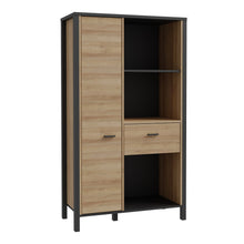 Load image into Gallery viewer, High Rock Wide Shelf Unit in Matt Black/Riviera Oak Furniture To Go 801hrkr521l-m197 5904767840686 High Rock, a captivating and contemporary collection which has a perfect blend of the Riviera Oak decor with deep black accents, this collection immediately captivates attention with its originality. The sleek black metal handles add a touch of elegance, while the tables boast robust metal legs in a frame-like design, contributing to a distinct loft character within the space. Beyond its striking aesthetics, H