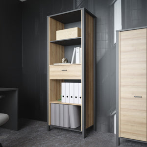 High Rock Shelf Unit in Matt Black/Riviera Oak Furniture To Go 801hrkr711-m197 5904767840679 High Rock, a captivating and contemporary collection which has a perfect blend of the Riviera Oak decor with deep black accents, this collection immediately captivates attention with its originality. The sleek black metal handles add a touch of elegance, while the tables boast robust metal legs in a frame-like design, contributing to a distinct loft character within the space. Beyond its striking aesthetics, High Ro