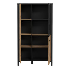 Load image into Gallery viewer, High Rock Small Display Cabinet in Matt Black/Riviera Oak Furniture To Go 801hrkv521-m197 5904767827199 High Rock, a captivating and contemporary collection which has a perfect blend of the Riviera Oak decor with deep black accents, this collection immediately captivates attention with its originality. The sleek black metal handles add a touch of elegance, while the tables boast robust metal legs in a frame-like design, contributing to a distinct loft character within the space. Beyond its striking aestheti