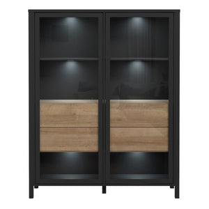 High Rock Extra Wide Display Cabinet in Matt Black/Riviera Oak Furniture To Go 801hrkv522-m197 5904767825508 High Rock, a captivating and contemporary collection which has a perfect blend of the Riviera Oak decor with deep black accents, this collection immediately captivates attention with its originality. The sleek black metal handles add a touch of elegance, while the tables boast robust metal legs in a frame-like design, contributing to a distinct loft character within the space. Beyond its striking aes