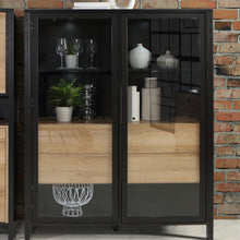 Load image into Gallery viewer, High Rock Extra Wide Display Cabinet in Matt Black/Riviera Oak Furniture To Go 801hrkv522-m197 5904767825508 High Rock, a captivating and contemporary collection which has a perfect blend of the Riviera Oak decor with deep black accents, this collection immediately captivates attention with its originality. The sleek black metal handles add a touch of elegance, while the tables boast robust metal legs in a frame-like design, contributing to a distinct loft character within the space. Beyond its striking aes