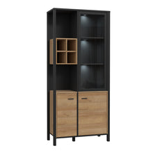 Load image into Gallery viewer, High Rock Display Cabinet in Matt Black/Riviera Oak Furniture To Go 801hrkv721r-m197 5904767825522 High Rock, a captivating and contemporary collection which has a perfect blend of the Riviera Oak decor with deep black accents, this collection immediately captivates attention with its originality. The sleek black metal handles add a touch of elegance, while the tables boast robust metal legs in a frame-like design, contributing to a distinct loft character within the space. Beyond its striking aesthetics, H