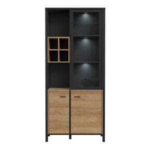 High Rock Display Cabinet in Matt Black/Riviera Oak Furniture To Go 801hrkv721r-m197 5904767825522 High Rock, a captivating and contemporary collection which has a perfect blend of the Riviera Oak decor with deep black accents, this collection immediately captivates attention with its originality. The sleek black metal handles add a touch of elegance, while the tables boast robust metal legs in a frame-like design, contributing to a distinct loft character within the space. Beyond its striking aesthetics, H