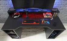 Load image into Gallery viewer, Tezaur Gaming Desk with Blue LED in Matt Black Furniture To Go 801tzrb215b3-z113 5904767896584 Bold, stylish, and designed to cater to every gaming enthusiast&#39;s dream, the Tezaur is more than just a desk; it&#39;s an experience. Crafted with precision and attention to detail, this masterpiece is the perfect companion for your customers gaming consoles, elevating their setup to new heights. And let&#39;s talk about lighting - the Tezaur takes it to the next level. Embedded with built-in strip lights, this desk will 