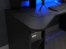 Load image into Gallery viewer, Tezaur Gaming Desk with LED in Matt Black Furniture To Go 801tzrb221b3-z113 5904767836054 Bold, stylish, and designed to cater to every gaming enthusiast&#39;s dream, the Tezaur is more than just a desk; it&#39;s an experience. Crafted with precision and attention to detail, this masterpiece is the perfect companion for your customers gaming consoles, elevating their setup to new heights. And let&#39;s talk about lighting - the Tezaur takes it to the next level. Embedded with built-in strip lights, this desk will trans
