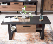Load image into Gallery viewer, Nordi Coffee Table Arte-N A4NRSK900 Its modern, rectangular design makes this coffee table versatile highly practical. Two open compartments on either side of the drawer provide storage space for magazines, newspapers other daily essentials, while the drawer itself is large enough to store remote controllers, casual snacks similar small items without cramping your visual space. Finished in an elegant combination of matt black warm oak tones, this stylish coffee table will enhance any decor. W110cm x H48cm x