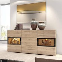 Load image into Gallery viewer, Baros 26 - Sideboard Cabinet Arte-N 24O1BM26 Made from the finest materials with stunning features, this sideboard cabinet from the Baros collection is a glamorously designed furniture for those who value aesthetics. It boasts two partially-glazed hinged doors a trio of drawers, providing display space for prized possessions concealed space for essentials mundane items. Thanks to its elegant design, this sideboard will effortlessly enrich your interior. W132cm x H70cm x D39cm Colour: Concrete Grey Oak San R