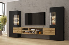 Load image into Gallery viewer, Coby 10 Entertainment Media Wall Unit Arte-N 247JMB10 W270cm x H143cm x D45cm Colour: Oak Wotan White Gloss [Matt Carcass] Oak Monastery Black Oak Wotan Black Four-Hinged Doors [Two Partially Glassed] Four Shelves Six Closed Compartments Four Open Compartments Cable Management System Optional LED Lighting [Purchased Separately] Matching Furniture Available Made from 16mm high-quality laminated board Assembly Required Weight: 116kg Estimated Direct Home Delivery Time: 4-6 Weeks *Fixings for wall mounting are