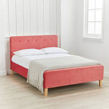 Load image into Gallery viewer, Pierre Coral Double Bed LPD PIERRECOR4.6* 5036464075204 Crushed Velvet Colour: Coral Dimensions: 1040mm x 1445mm x 2085mm The Pierre Double Bed is a simple yet stylish soft, velvet Coral upholstered bed with contrasting light wooden legs and a classic button detail to the headboard. Elegantly clad in the same Coral upholstery as the headboard, the frame and footboard is inviting and sumptuous. Characterising a relaxing and calm environment, this bed is delicious in its design and will make any bedroom into 