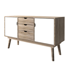 Load image into Gallery viewer, Scandi Oak 2 Door Sideboard White LPD SCANDISIDEWHI* 5036464057088 MDF Colour: White Dimensions: 770mm x 1250mm x 450mm Completing an affordable, retro range of furniture, the Scandi 3 Drawer Oak Sideboard features angled legs and a large table surface inlaid with 2 cupboards and 3 drawer combination for storage. Finished in oak with accent white cupboard doors, this design is ideal for those looking for unique style, practical storage options and something a bit more adventurous from living area.