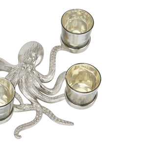Silver Octopus Four Tealight Holder in SILVER Hill Interiors 22225 5050140222584 Dimensions: 8cm x 24cm x 30cm Weight: 0.9kg Volume: 0.06CBM This is the Silver Octopus Four Tealight Holder. A stylish and beautifully detailed silver octopus, holds four handcrafted glass votives within its eight legs, protecting your favourite tealight candle's flame. Individually handcrafted with beautiful detailing, it will elevate any space. Simply fill with your favourite candle and enjoy! Compatible with our three wick, 