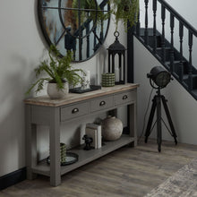 Load image into Gallery viewer, The Oxley Collection Three Drawer Console Table in GREY Hill Interiors 22537 5050140253786 Timeless and durable Versatile colourway Handcrafted White glove delivery Dimensions: 78cm x 150cm x 40cm Weight: 33kg Volume: 0.26CBM The Oxley Collection Three Drawer Console Table is perfect for display as well as storage. A washed wood plank surface blended with a frame in a warm grey hue deliver a relaxed, informal feel to any space. Stylish as well as functional, this high quality item would be equally at home i